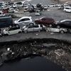 Vehicles damaged by last years tsunami sit stacked on each other in a holding yard in Ischinomaki, Japan. As the one year anniversary approaches, the areas most affected by an earthquake and subsequent tsunami that left 15,848 dead and 3,305 missing according to Japan\